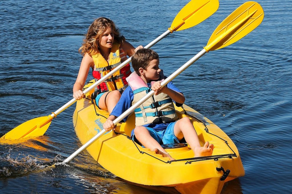 Kids kayaking in river